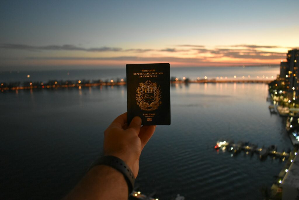 Person holding up their passport, showcasing the process of how to do a working holiday visa in Australia.