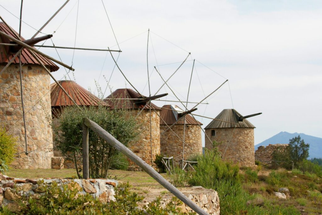 Old fashioned stone windmills in Portugal. All laid in a rown on a hillside in portugal.