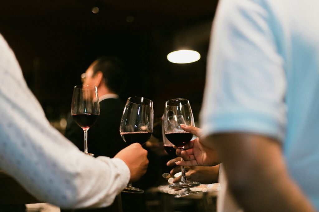 two people clinking wine glasses. showcasing wine tasting to be one of the best things to do in alentejo.